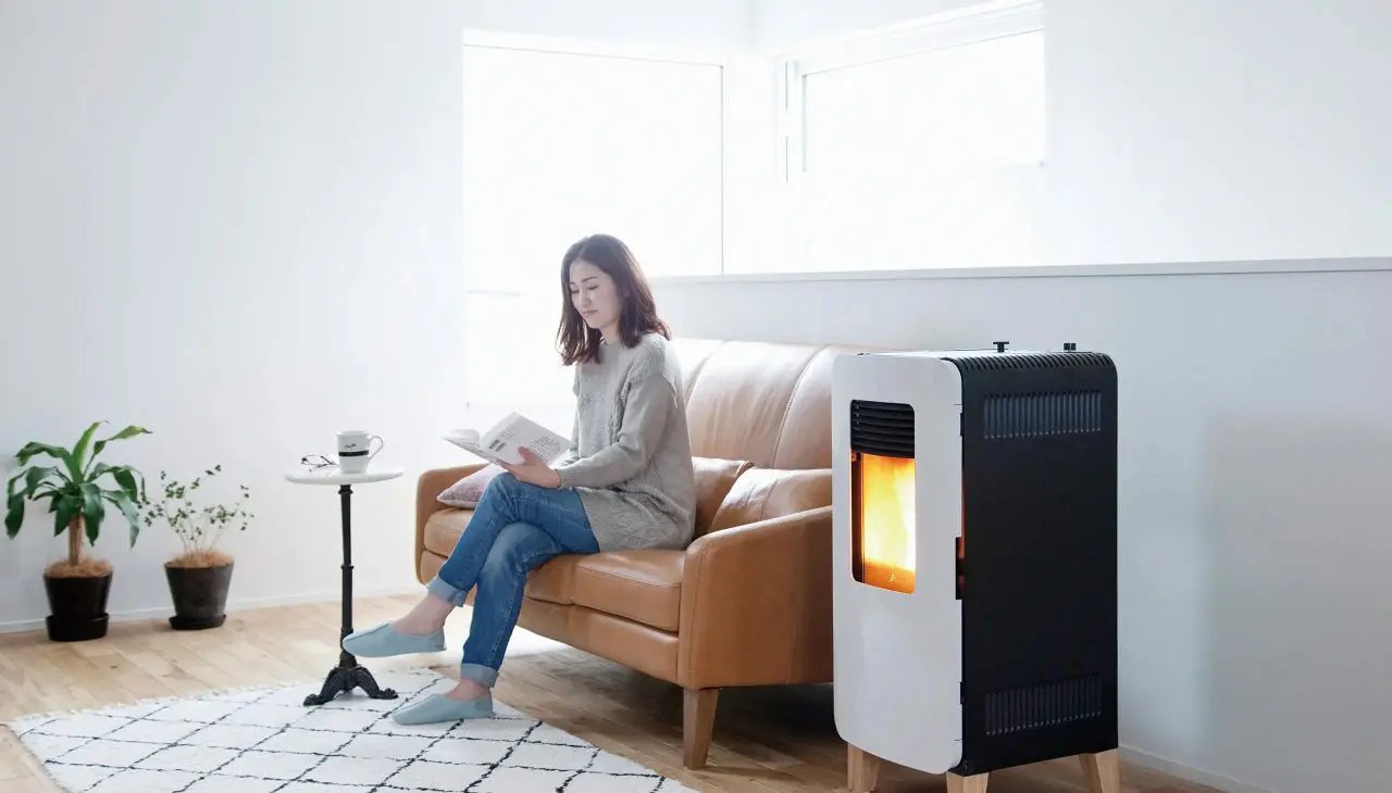 トヨトミ PE-6 ペレットストーブのそばでソファに座り読書する暮らし